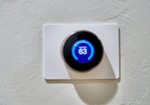 Programmable smart thermostat that reads "heat set to 63"