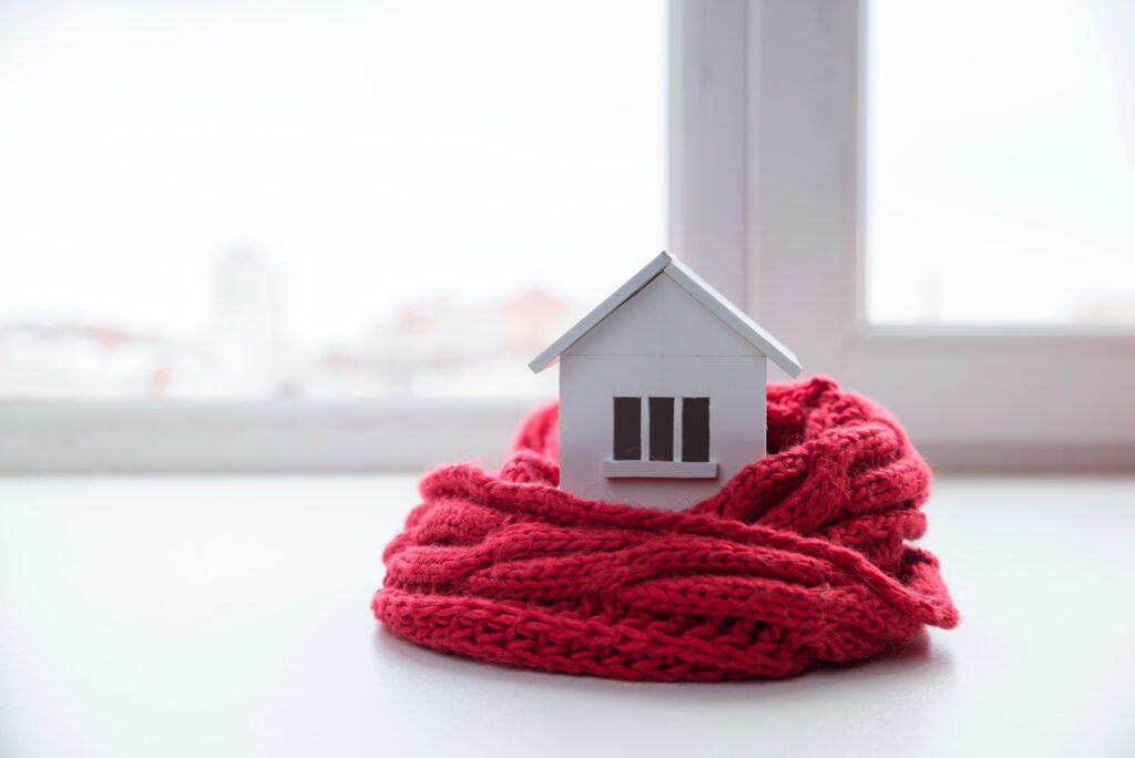 small model house in a red knit blanket